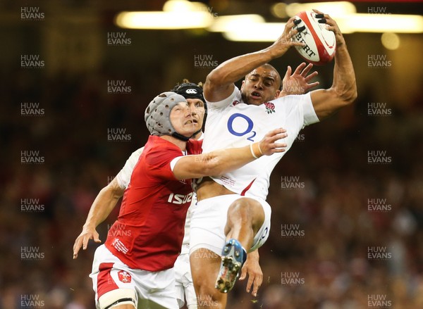 170819 - Wales v England, Under Armour Summer Series 2019 - Jonathan Joseph of England takes the ball under pressure from Jonathan Davies of Wales