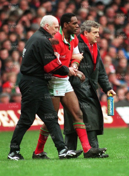 180295 - Wales v England - Five Nations - Nigel Walker of Wales taken off injured assisted by Tudor Jones (physio) and Dr Roger Evans (rightt)