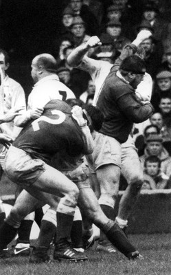 180389 - Wales v England - Five Nations -   Ian Watkins of Wales (2) grapples with an England player whilst Mike Griffiths exchanges blows with Dean Richards behind as Gareth Chilcott of England walks away