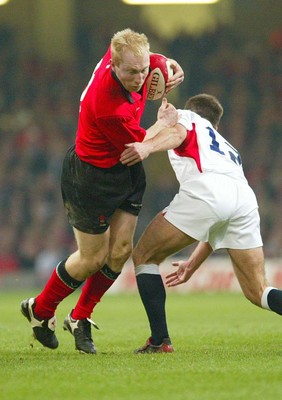 220203 - Wales v England - Six Nations Championship - Wales' Tom Shanklin is tackled by Charlie Hodgson