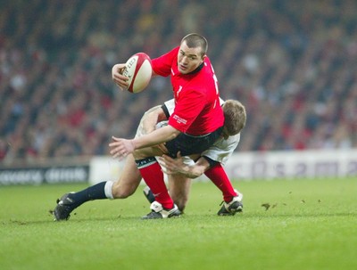 220203 - Wales v England - Six Nations Championship - Wales' Iestyn Harris is tackled by Will Greenwood