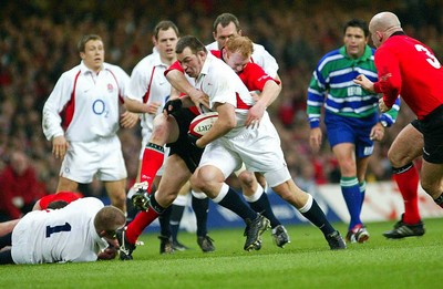 220203 - Wales v England - Six Nations Championship - England's Steve Thompson is tackled by Martyn Williams