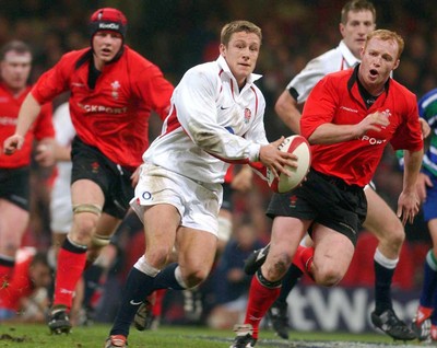 220203 - Wales v England - Six Nations Championship -  Jonny Wilkinson is chased by Martyn Williams and Dafydd Jones