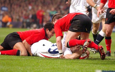 220203 - Wales v England - Six Nations Championship - England's Joe Worsley sneaks in beneath Ceri Sweeney as Gavin Thomas tackles, to score try