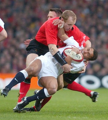 220203 - Wales v England - Six Nations Championship - England's Jason Robinson is tackled by Gareth Thomas