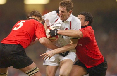 220203 - Wales v England - Six Nations Championship - England's Will Greenwood is tackled by Steve Williams and Gavin Thomas