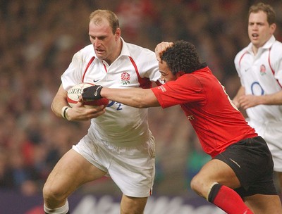 220203 - Wales v England - Six Nations Championship - England's Lawrence Dallaglio hands off Gavin Thomas