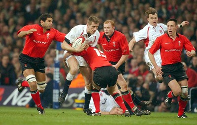 220203 - Wales v England - Six Nations Championship - England Will Greenwood is tackled by Kevin Morgan and Colin Charvis