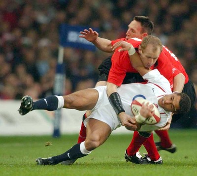 220203 - Wales v England - Six Nations Championship - England's Jason Robinson is tackled by Gareth Thomas