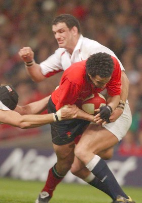 220203 - Wales v England - Six Nations Championship - Wales' Gavin Thomas is tackled by Martin Johnson