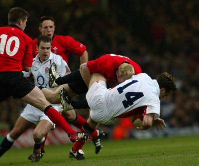 220203 - Wales v England - Six Nations Championship - Wales Centre Tom Shanklin dumps England wing Dan Luger