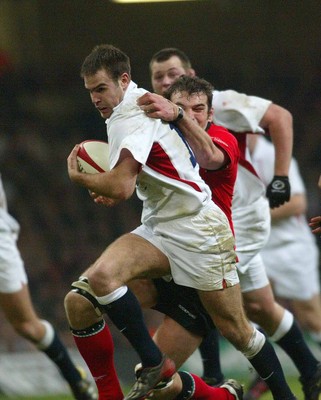 220203 - Wales v England - Six Nations Championship - England Centre Charlie Hodgson tries to get away from Wales Lock Robert Sidoli