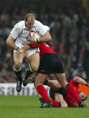 220203 - Wales v England - Six Nations Championship - England No8 Lawrence Dallaglio leaps into the air as he gets caught by Steve Williams