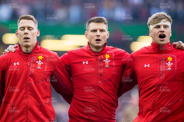 230219 - Wales v England, Guinness Six Nations  - Liam Williams, Dan Biggar and Aaron Wainwright of Wales sing the anthem