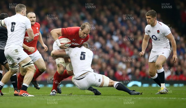 230219 - Wales v England - Guinness 6 Nations Championship - Alun Wyn Jones of Wales is tackled by George Kruis of England
