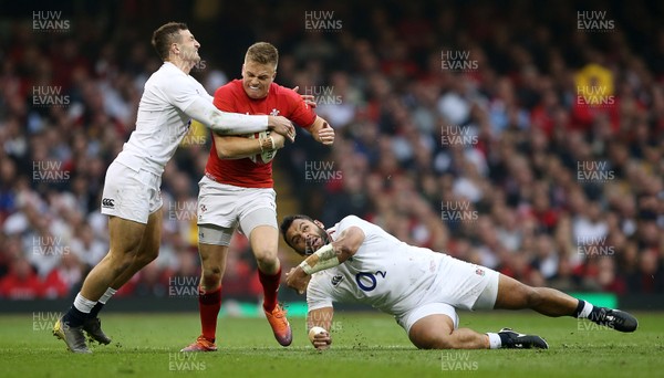 230219 - Wales v England - Guinness 6 Nations Championship - Gareth Anscombe of Wales is tackled by Jonny May and Billy Vunipola of England