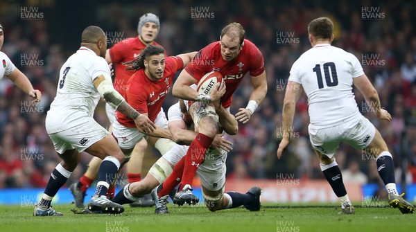 230219 - Wales v England - Guinness 6 Nations Championship - Alun Wyn Jones of Wales is tackled by George Kruis of England