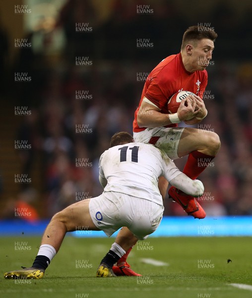 230219 - Wales v England - Guinness 6 Nations Championship - Josh Adams of Wales is tackled by Jonny May of England