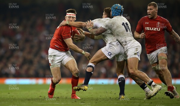 230219 - Wales v England - Guinness 6 Nations Championship - Josh Adams of Wales gets past Henry Slade of England