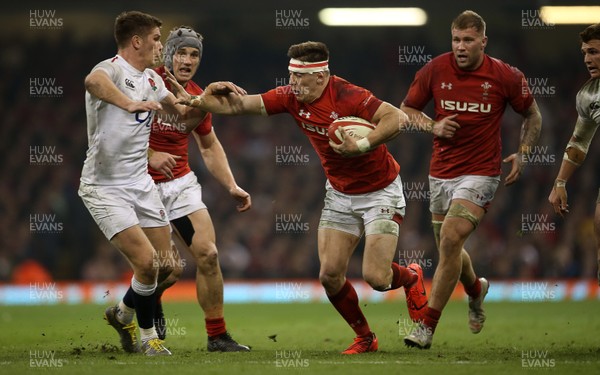 230219 - Wales v England - Guinness 6 Nations Championship - Josh Adams of Wales is tackled by Owen Farrell of England