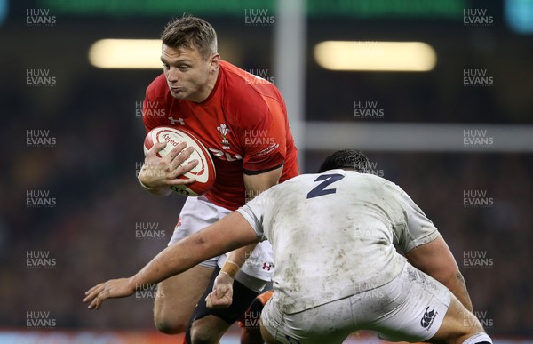 230219 - Wales v England - Guinness 6 Nations Championship - Dan Biggar of Wales is tackled by Jamie George of England