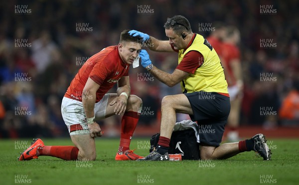 230219 - Wales v England - Guinness 6 Nations Championship - Josh Adams of Wales is seen to by the team doctor