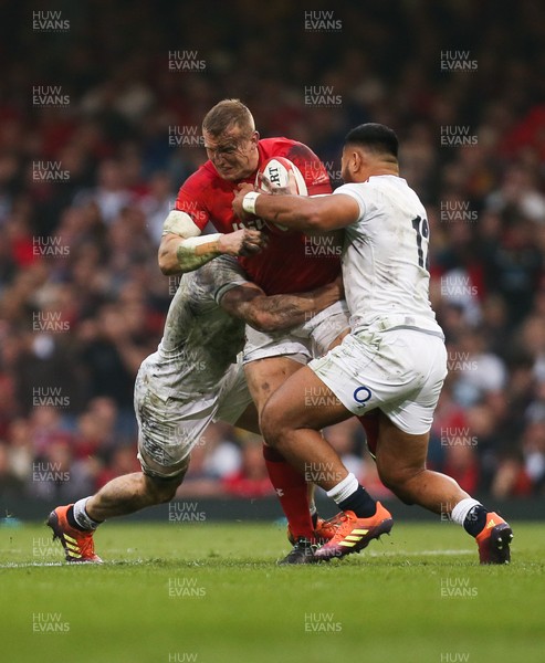 230219 - Wales v England, Guinness Six Nations - Hadleigh Parkes of Wales is tackled by Manu Tuilagi of England and Tom Curry of England