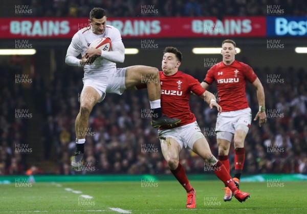 230219 - Wales v England, Guinness Six Nations - Jonny May of England takes the ball as Josh Adams of Wales challenges