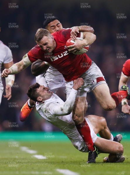 230219 - Wales v England, Guinness Six Nations - Hadleigh Parkes of Wales is tackled by Manu Tuilagi of England and Jonny May of England