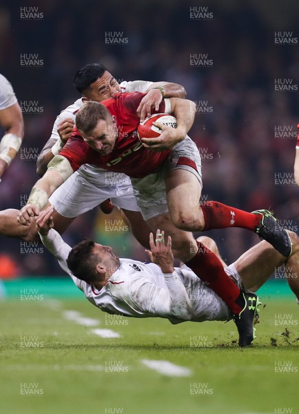 230219 - Wales v England, Guinness Six Nations - Hadleigh Parkes of Wales is tackled by Manu Tuilagi of England and Jonny May of England