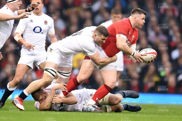 230219 - Wales v England - Guinness Six Nations - Rob Evans of Wales is tackled by George Kruis of England 