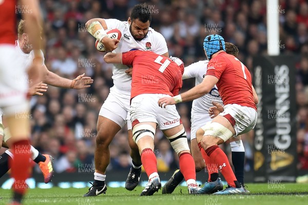 230219 - Wales v England - Guinness Six Nations - Billy Vunipola of England  is tackled by Cory Hill of Wales 