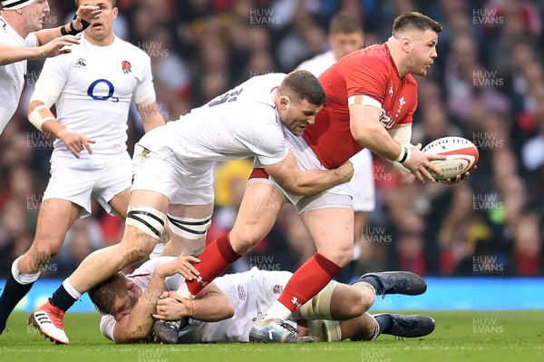 230219 - Wales v England - Guinness Six Nations - Rob Evans of Wales is tackled by George Kruis of England 