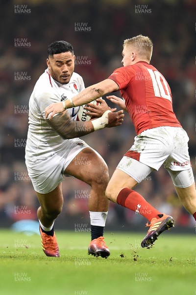 230219 - Wales v England - Guinness Six Nations - Manu Tuilagi of England is tackled by Gareth Anscombe of Wales 