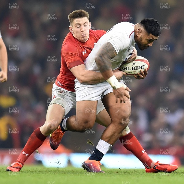 230219 - Wales v England - Guinness Six Nations - Manu Tuilagi of England is tackled by Josh Adams of Wales 