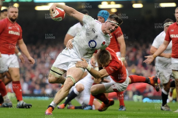 230219 - Wales v England - Guinness Six Nations - Tom Curry of England is tackled by Liam Williams of Wales 