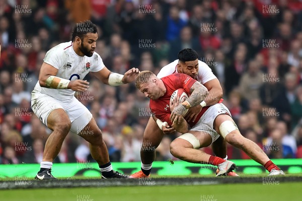 230219 - Wales v England - Guinness Six Nations - Ross Moriarty of Wales is tackled by Billy Vunipola of England and Manu Tuilagi of England 