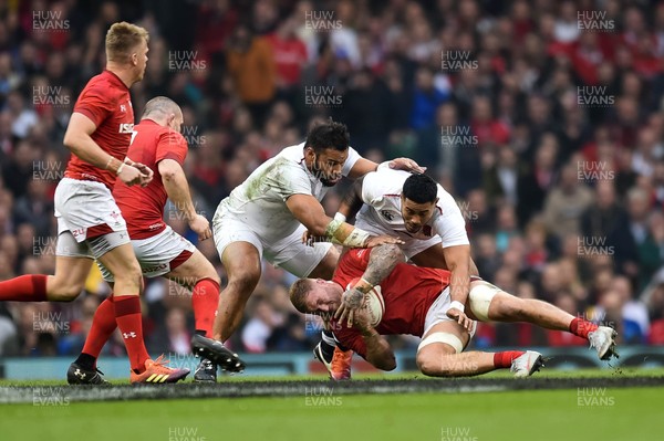 230219 - Wales v England - Guinness Six Nations -  Ross Moriarty of Wales is tackled by Billy Vunipola of England and Manu Tuilagi of England 