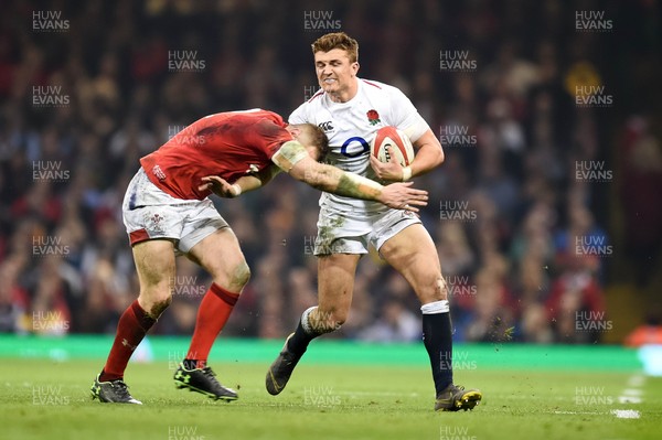 230219 - Wales v England - Guinness Six Nations - Henry Slade of England  is tackled by Hadleigh Parkes of Wales 