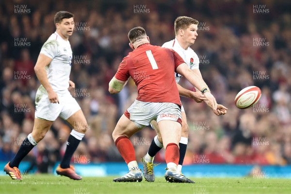 230219 - Wales v England - Guinness Six Nations - Owen Farrell of England  is tackled by Rob Evans of Wales 