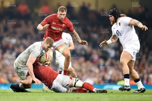 230219 - Wales v England - Guinness Six Nations - George Kruis of England is tackled by Cory Hill of Wales 