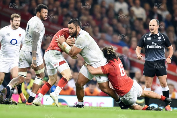230219 - Wales v England - Guinness Six Nations - Billy Vunipola of England is tackled by Josh Navidi of Wales 