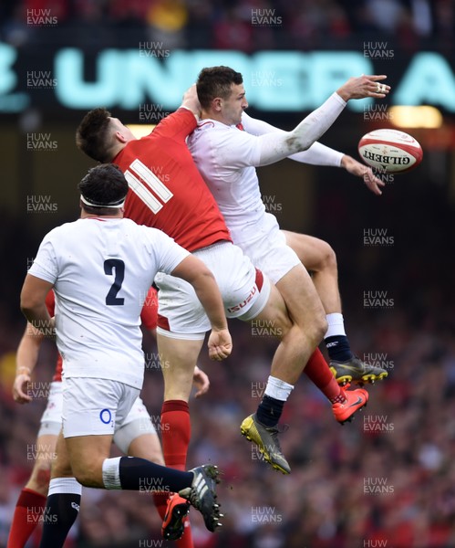 230219 - Wales v England - Guinness Six Nations Championship -  Josh Adams of Wales and Jonny May of England compete in the air