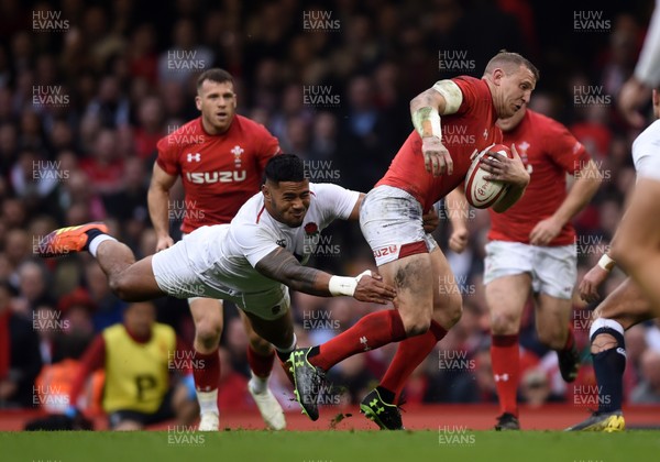 230219 - Wales v England - Guinness Six Nations Championship -  Hadleigh Parkes of Wales is tackled by Manu Tuilagi of England 