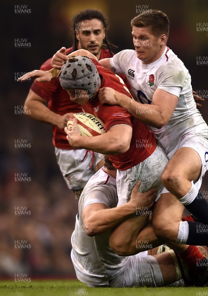 230219 - Wales v England - Guinness Six Nations - Jonathan Davies of Wales is tackled by Joe Launchbury and Owen Farrell of England