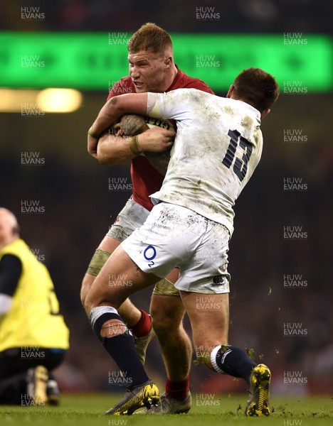 230219 - Wales v England - Guinness Six Nations - Ross Moriarty of Wales is tackled by Henry Slade of England