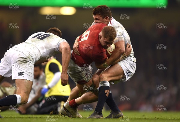 230219 - Wales v England - Guinness Six Nations - Ross Moriarty of Wales is tackled by Owen Farrell and Henry Slade of England