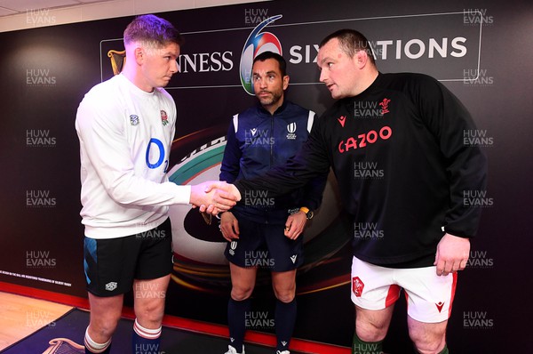 250223 - Wales v England - Guinness Six Nations 2023 - Owen Farrell of England, Referee Mathieu Raynal and Ken Owens of Wales during the coin toss