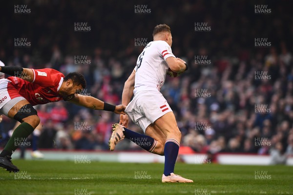 250223 - Wales v England - Guinness Six Nations 2023 - Freddie Steward of England is tackled by Taulupe Faletau of Wales