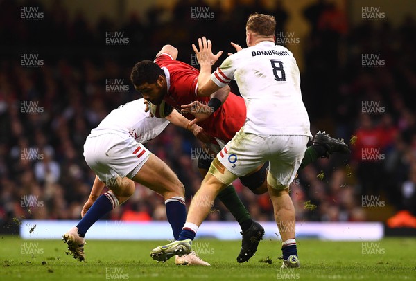 250223 - Wales v England - Guinness Six Nations 2023 - Taulupe Faletau of Wales is tackled by Jack van Poortvliet of England